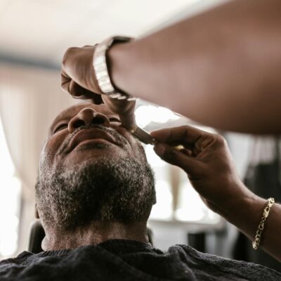 A serene moment during a beard trim in a barbershop, featuring skilled hands and focused attention.