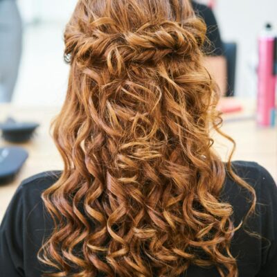 Rear view of elegant curly hairstyle in a hair salon setting.