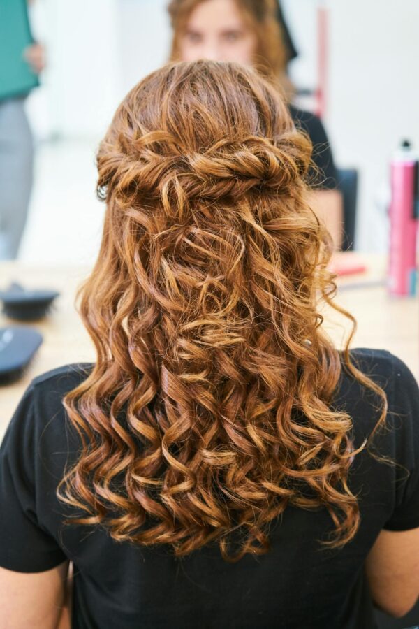 Rear view of elegant curly hairstyle in a hair salon setting.